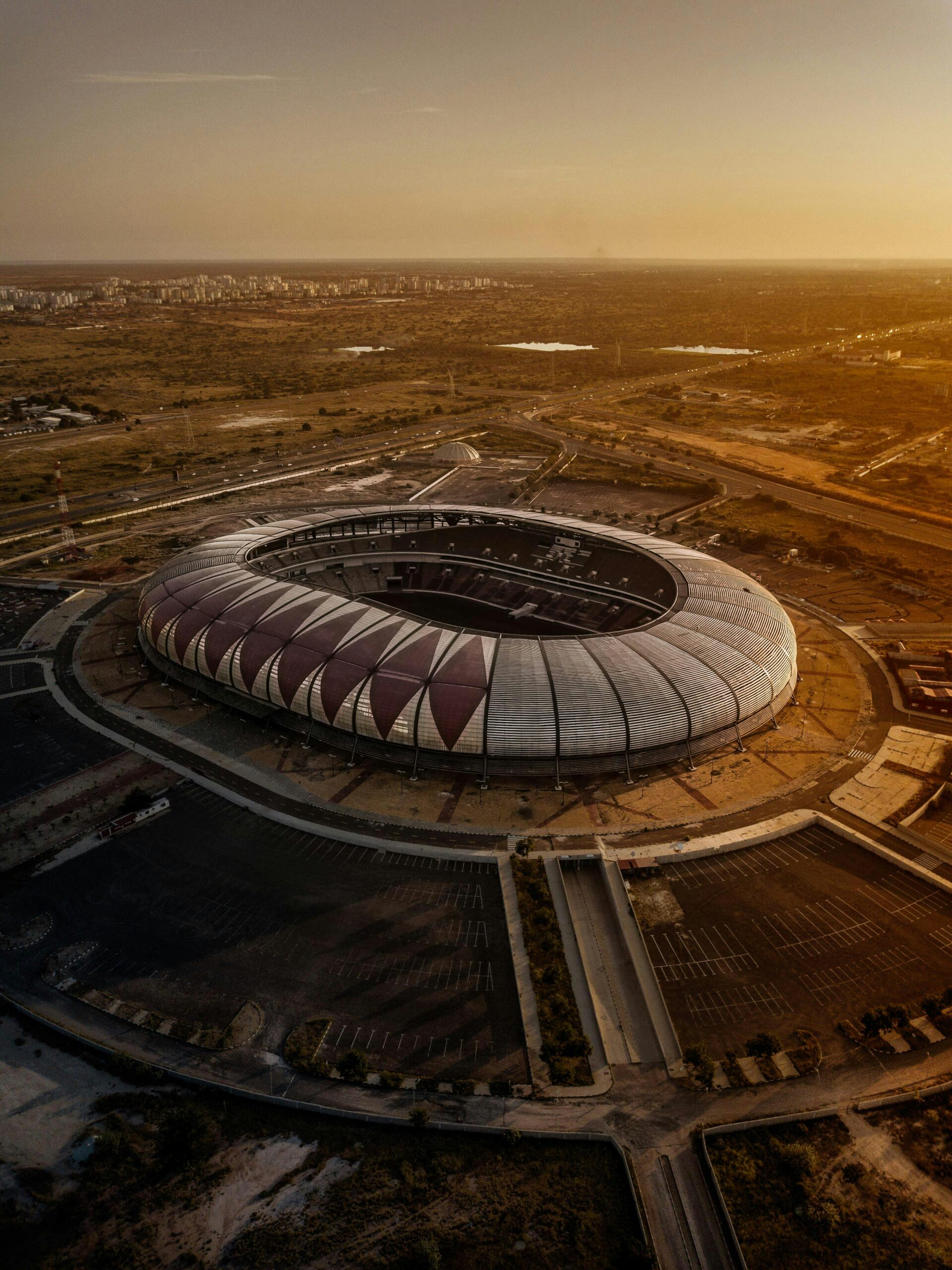 Aerial shot of Estádio 11 de Novembro in Luanda, Angola during sunset, capturing its modern architecture.